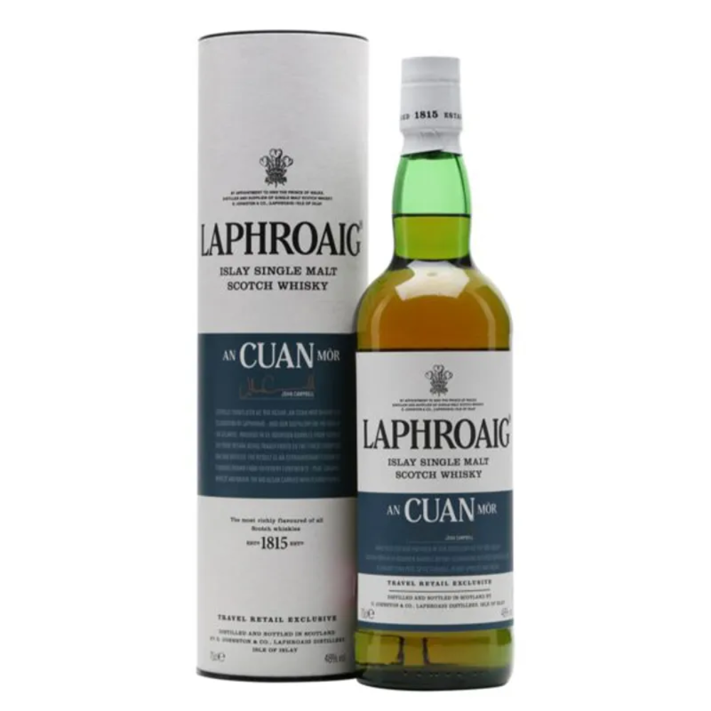 A bottle of Laphroaig An Cuan Mòr single malt Scotch whisky next to its packaging box.