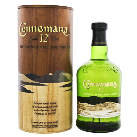 Connemara 12-year-old single malt Irish whiskey bottle and wooden box on a white background
