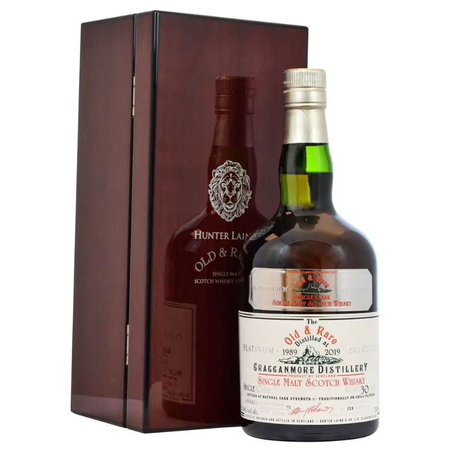 Two bottles of whisky, one in a wooden box, on a white background