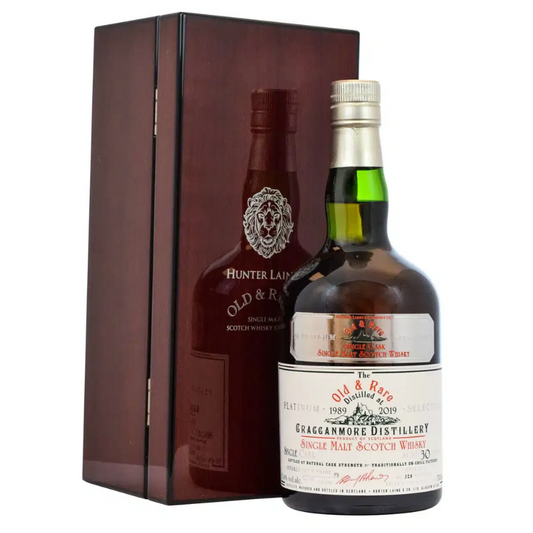 Two bottles of whisky, one in a wooden box, on a white background