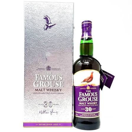 Bottle of The Famous Grouse Malt Whisky with packaging on a white background