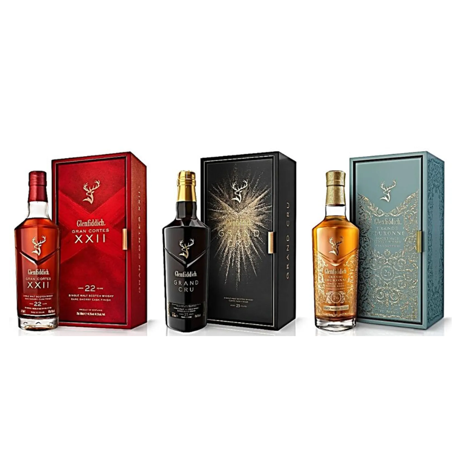 Four Glenfiddich whisky bottles with their respective boxes on a white background