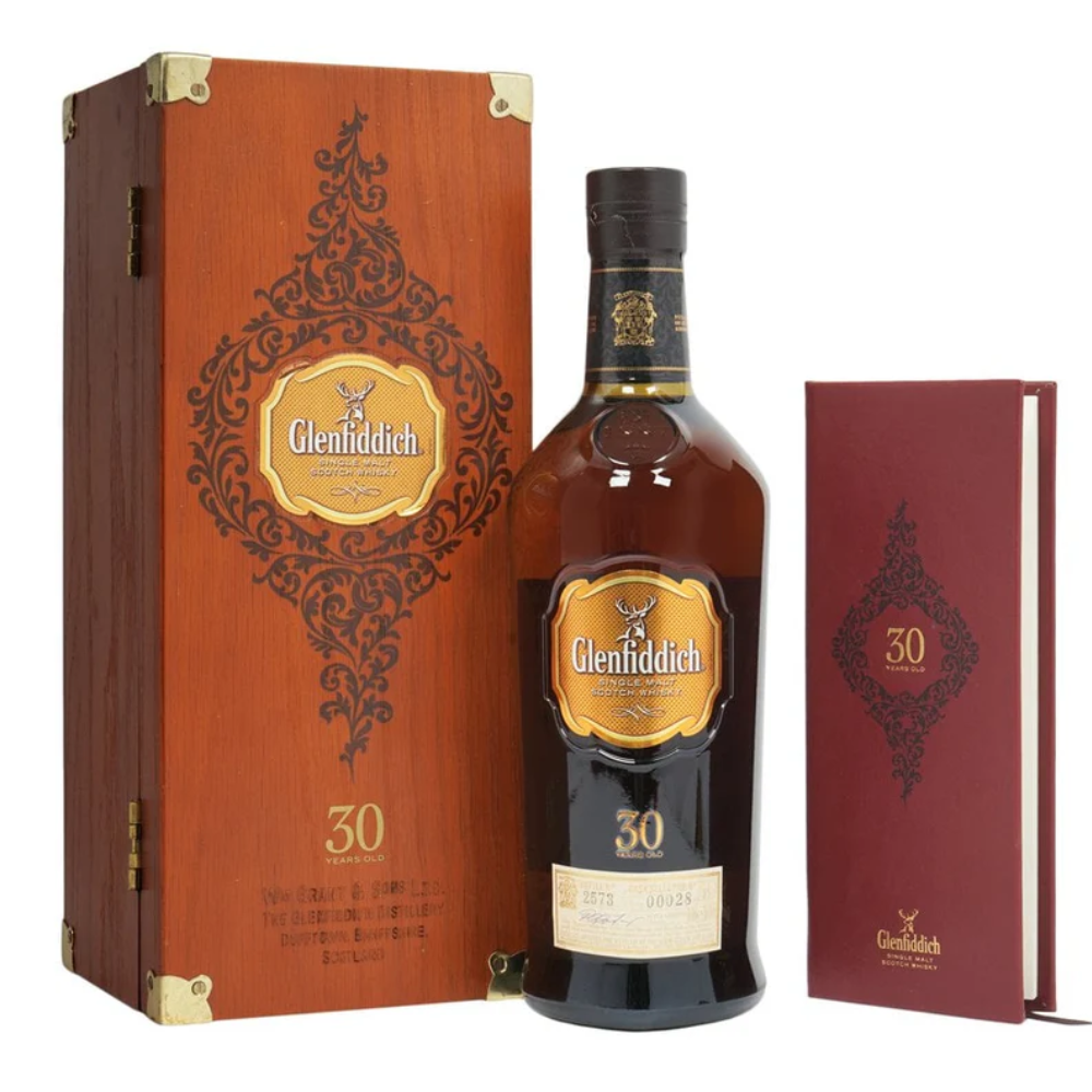 Glenfiddich 30 Year Old Single Malt Scotch Whisky in a vintage wooden box with a damage interior, bottle in great condition, and a red book.