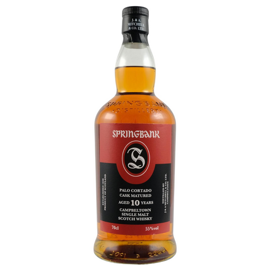 A bottle of Springbank 10 Palo Cortado single malt Scotch whisky, with a red label and black text, indicating it is cask matured.